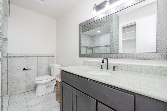 3733 Magnolia Dr, Grand Prairie, TX 75052 - full bath with tile patterned flooring, vanity, tile walls, tiled shower, and wainscoting