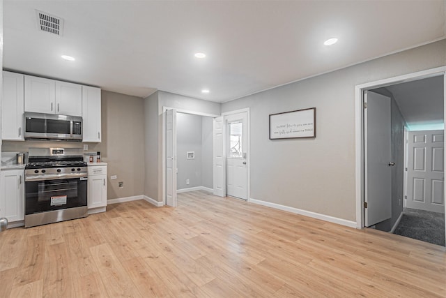 5307 Kelly Elliott, Arlington, TX 76017 - kitchen featuring appliances with stainless steel finishes, light countertops, white cabinetry, light wood finished floors, and recessed lighting