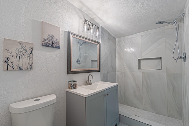 5307 Kelly Elliott, Arlington, TX 76017 - bathroom featuring a shower, vanity, a textured ceiling, and a textured wall