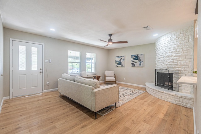 5307 Kelly Elliott, Arlington, TX 76017 - living room featuring light wood finished floors, a ceiling fan, a stone fireplace, and recessed lighting