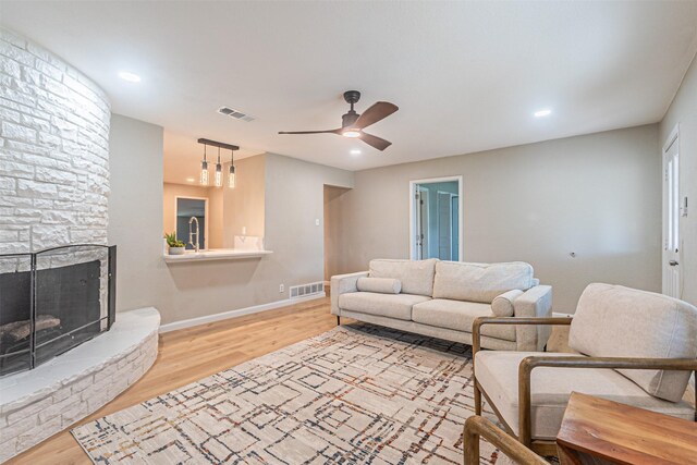 5307 Kelly Elliott, Arlington, TX 76017 - living area featuring light wood finished floors, ceiling fan, recessed lighting, and a stone fireplace