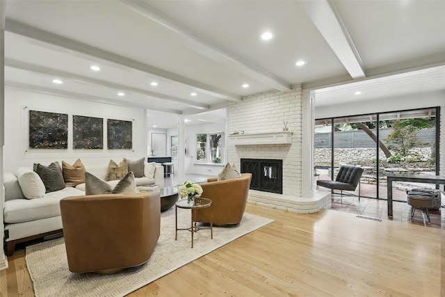 208 Rockwood Park Dr, Fort Worth, TX 76107 - living room with beam ceiling, light wood-style floors, a brick fireplace, and recessed lighting