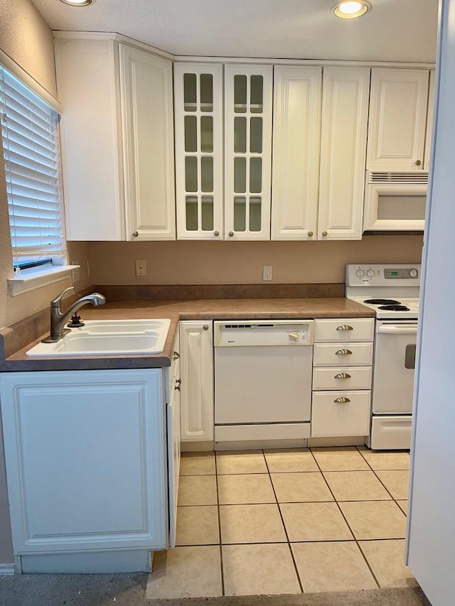 817 W Harwood Rd Unit B, Hurst, TX 76054 - kitchen featuring white appliances, white cabinets, glass insert cabinets, light tile patterned floors, and recessed lighting