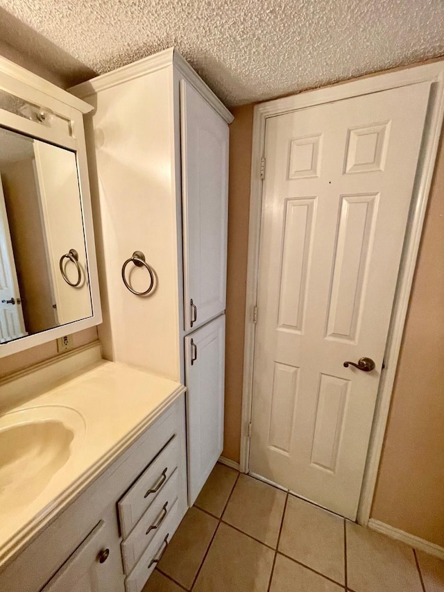 817 W Harwood Rd Unit B, Hurst, TX 76054 - bathroom with tile patterned floors, vanity, and a textured ceiling