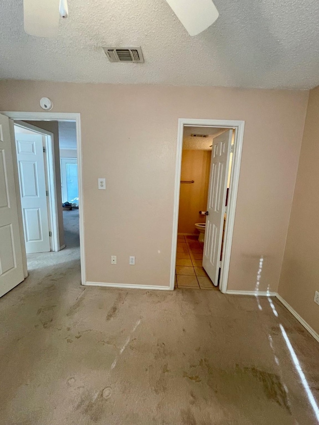 817 W Harwood Rd Unit B, Hurst, TX 76054 - unfurnished bedroom with carpet flooring, a textured ceiling, and ensuite bathroom