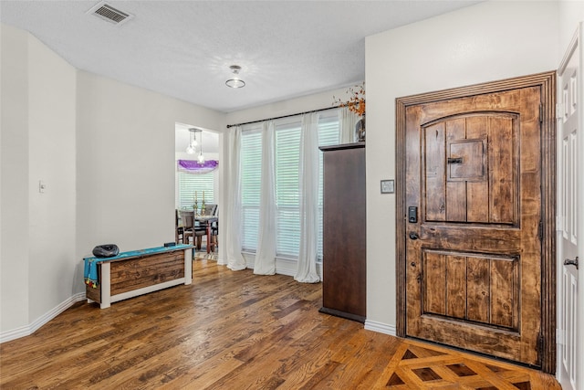 7210 Mercurys Rd, Rowlett, TX 75089 - foyer featuring wood finished floors and a textured ceiling