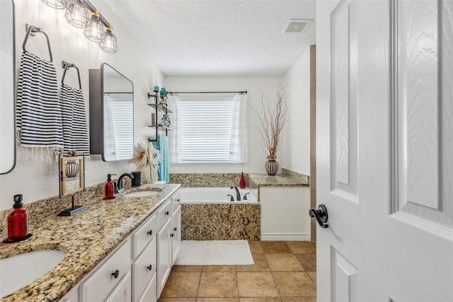 7210 Mercurys Rd, Rowlett, TX 75089 - full bath with a garden tub, double vanity, and a textured ceiling