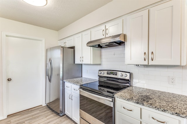 1704 Edge Hill Rd, Benbrook, TX 76126 - kitchen with appliances with stainless steel finishes, under cabinet range hood, light wood finished floors, white cabinets, and light stone countertops