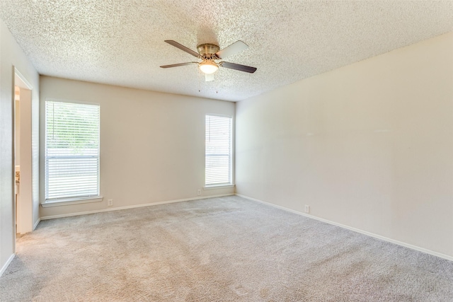 1704 Edge Hill Rd, Benbrook, TX 76126 - empty room featuring carpet, a textured ceiling, a ceiling fan, and healthy amount of natural light
