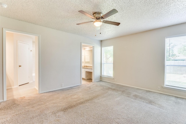 1704 Edge Hill Rd, Benbrook, TX 76126 - unfurnished bedroom with light colored carpet, a textured ceiling, ensuite bathroom, and ceiling fan