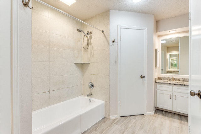 1704 Edge Hill Rd, Benbrook, TX 76126 - bathroom featuring shower / tub combination, vanity, a textured ceiling, and wood finished floors