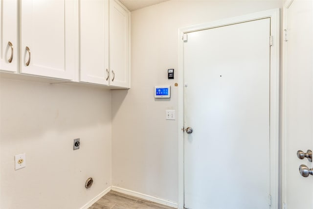 1704 Edge Hill Rd, Benbrook, TX 76126 - laundry area featuring hookup for an electric dryer, cabinet space, and light wood-style floors