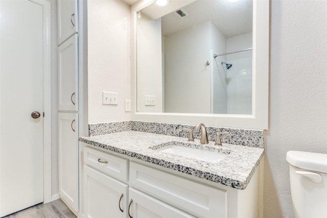 1704 Edge Hill Rd, Benbrook, TX 76126 - bathroom with vanity, wood finished floors, and a shower