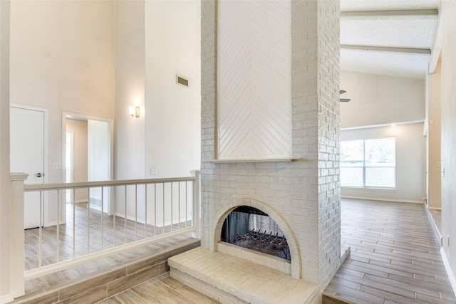 1704 Edge Hill Rd, Benbrook, TX 76126 - unfurnished living room featuring high vaulted ceiling, wood finish floors, and a fireplace
