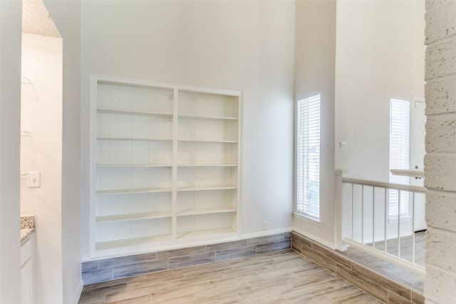 1704 Edge Hill Rd, Benbrook, TX 76126 - hallway with wood tiled floors, built in shelves, and a high ceiling