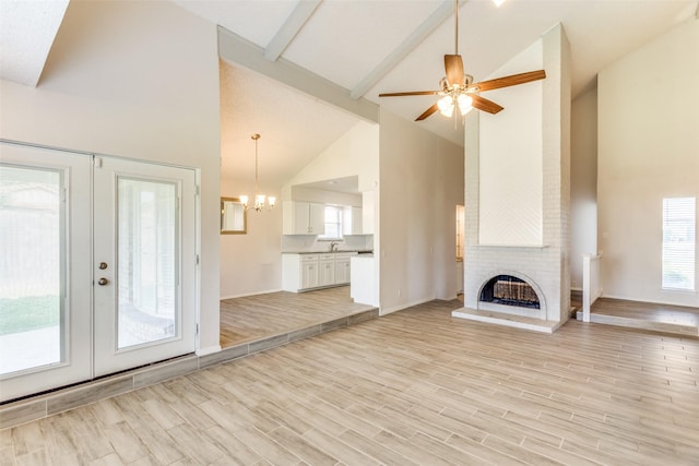 1704 Edge Hill Rd, Benbrook, TX 76126 - unfurnished living room featuring high vaulted ceiling, french doors, a chandelier, beamed ceiling, and a brick fireplace