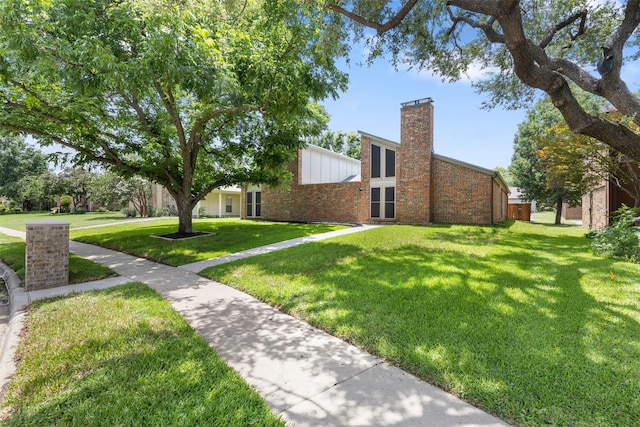 1513 Elk Grove Dr, Richardson, TX 75081 - view of side of home featuring a chimney, a lawn, and brick siding