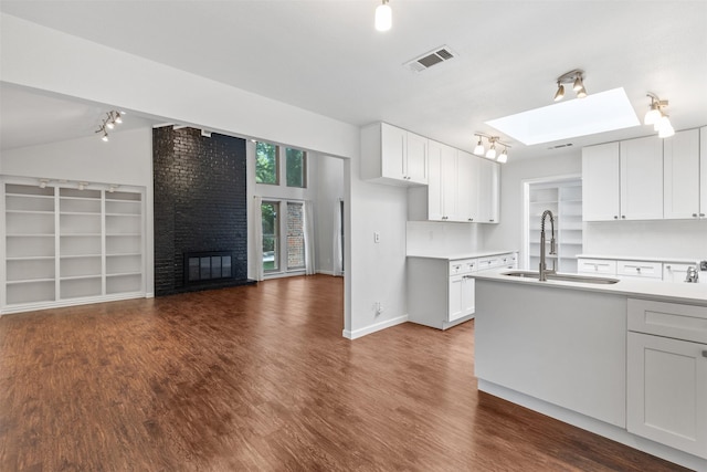 1513 Elk Grove Dr, Richardson, TX 75081 - kitchen with dark wood-style floors, rail lighting, light countertops, and open floor plan