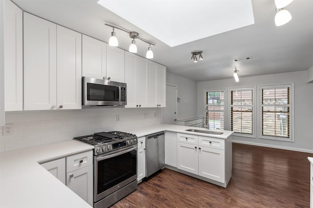 1513 Elk Grove Dr, Richardson, TX 75081 - kitchen with stainless steel appliances, a peninsula, light countertops, and decorative backsplash