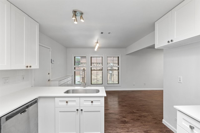 1513 Elk Grove Dr, Richardson, TX 75081 - kitchen with dishwasher, light countertops, dark wood-style floors, white cabinetry, and tasteful backsplash