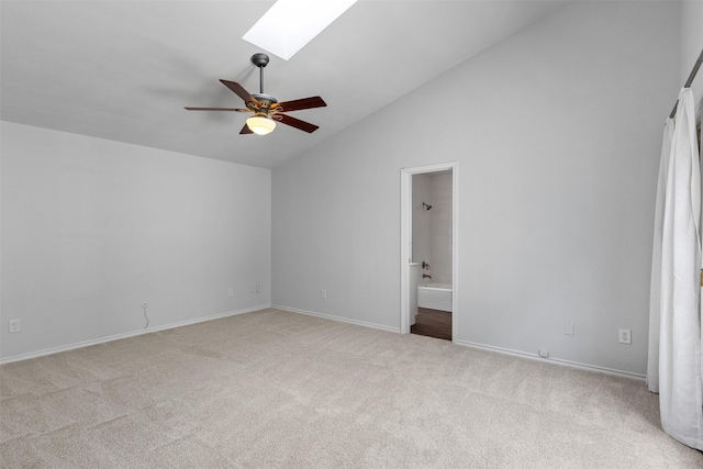 1513 Elk Grove Dr, Richardson, TX 75081 - carpeted empty room with vaulted ceiling, a ceiling fan, and a skylight