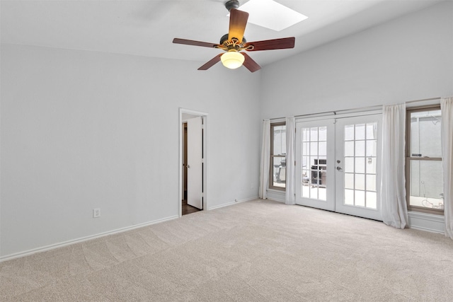 1513 Elk Grove Dr, Richardson, TX 75081 - carpeted spare room with a skylight, french doors, a ceiling fan, and high vaulted ceiling