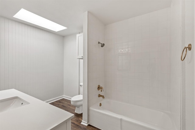 1513 Elk Grove Dr, Richardson, TX 75081 - bathroom with wood finished floors, vanity, bathing tub / shower combination, and a skylight