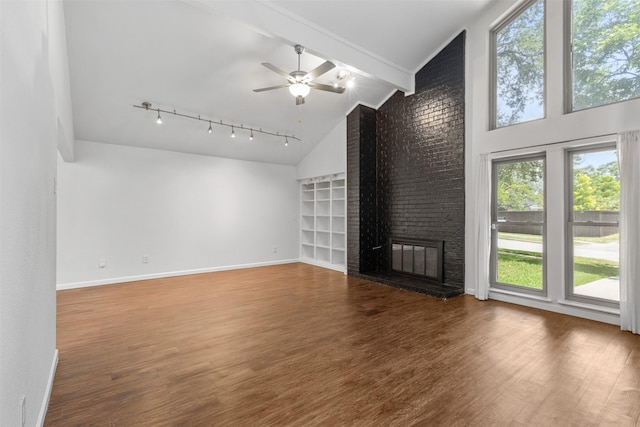1513 Elk Grove Dr, Richardson, TX 75081 - unfurnished living room with lofted ceiling, wood finished floors, a ceiling fan, a fireplace, and rail lighting