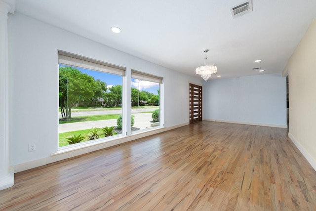 5710 Forest Ln, Dallas, TX 75230 - empty room featuring plenty of natural light, wood finished floors, a chandelier, and recessed lighting
