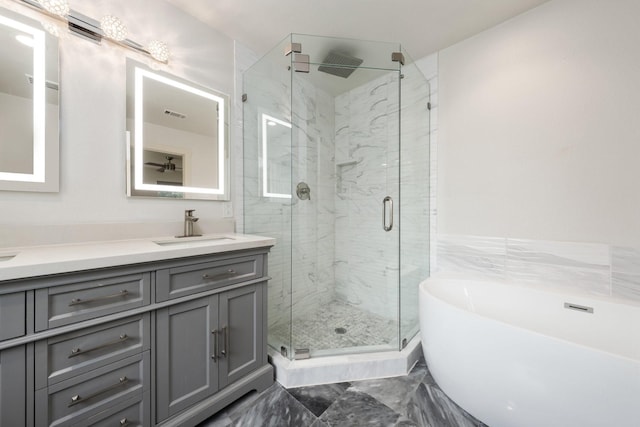 5710 Forest Ln, Dallas, TX 75230 - bathroom featuring a marble finish shower, a freestanding bath, double vanity, and marble finish floors