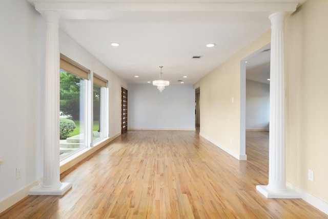5710 Forest Ln, Dallas, TX 75230 - empty room featuring decorative columns, light wood-style floors, and recessed lighting