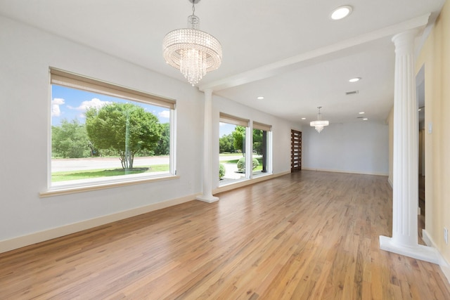 5710 Forest Ln, Dallas, TX 75230 - unfurnished living room with a chandelier, light wood finished floors, recessed lighting, and ornate columns