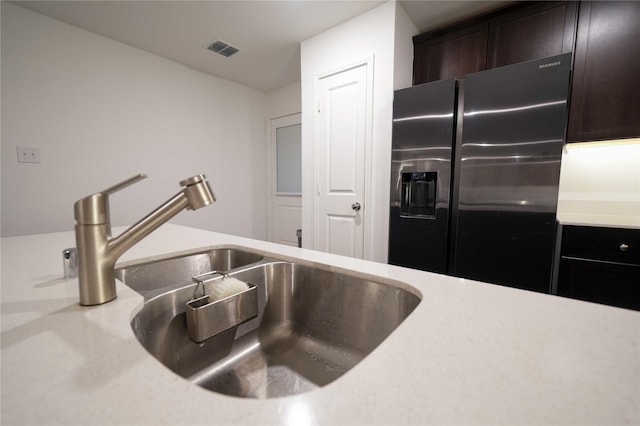 3117 Harper St, Little Elm, TX 75068 - kitchen with fridge with ice dispenser and dark brown cabinets