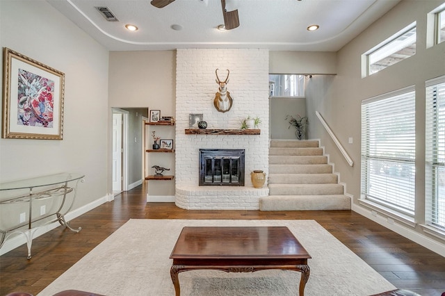 107 Sundance Ct, Hudson Oaks, TX 76087 - living area with wood finished floors, ceiling fan, a fireplace, and stairway
