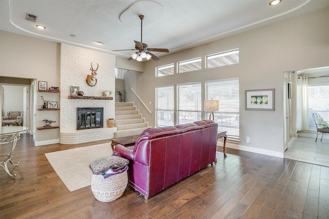 107 Sundance Ct, Hudson Oaks, TX 76087 - living area featuring a ceiling fan, wood finished floors, a brick fireplace, recessed lighting, and a towering ceiling