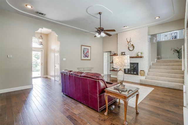 107 Sundance Ct, Hudson Oaks, TX 76087 - living room with a brick fireplace, a ceiling fan, dark wood finished floors, stairs, and recessed lighting
