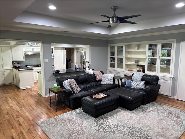 5620 Ridgetown Cir, Dallas, TX 75230 - living room with a raised ceiling, light wood finished floors, ceiling fan, recessed lighting, and ornamental molding