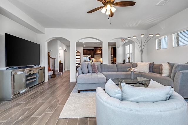 303 Hidden Cove Dr, Ponder, TX 76259 - living room with arched walkways, a ceiling fan, wood finished floors, and stairway