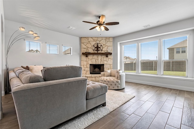 303 Hidden Cove Dr, Ponder, TX 76259 - living area featuring a ceiling fan, dark wood-type flooring, and a fireplace