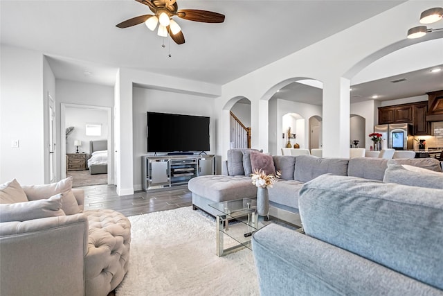 303 Hidden Cove Dr, Ponder, TX 76259 - living area featuring ceiling fan, arched walkways, and wood finished floors