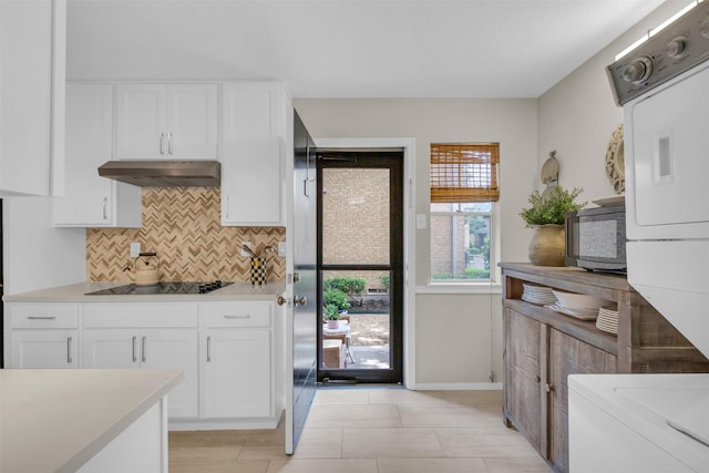 10763 Villager Unit A, Dallas, TX 75230 - kitchen featuring black appliances, under cabinet range hood, tasteful backsplash, light countertops, and white cabinetry