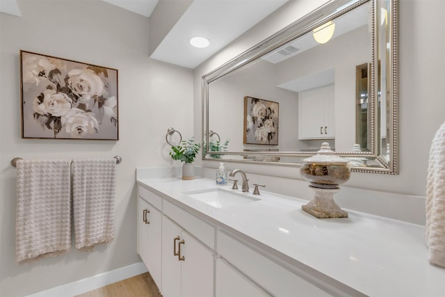 10763 Villager Unit A, Dallas, TX 75230 - bathroom featuring vanity and wood finished floors