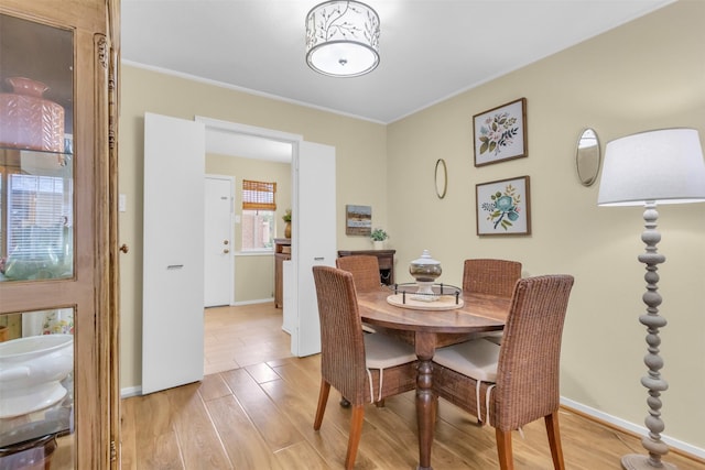 10763 Villager Unit A, Dallas, TX 75230 - dining area with light wood-style flooring and ornamental molding