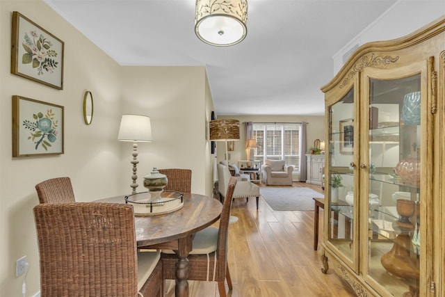 10763 Villager Unit A, Dallas, TX 75230 - dining room featuring light wood-style floors