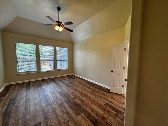 205 Boardwalk Ave, Waxahachie, TX 75165 - spare room featuring dark wood finished floors, a ceiling fan, vaulted ceiling, and a textured ceiling