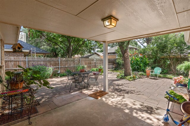 9013 Topperwind Ct, Fort Worth, TX 76134 - fenced backyard with outdoor dining space and a patio area