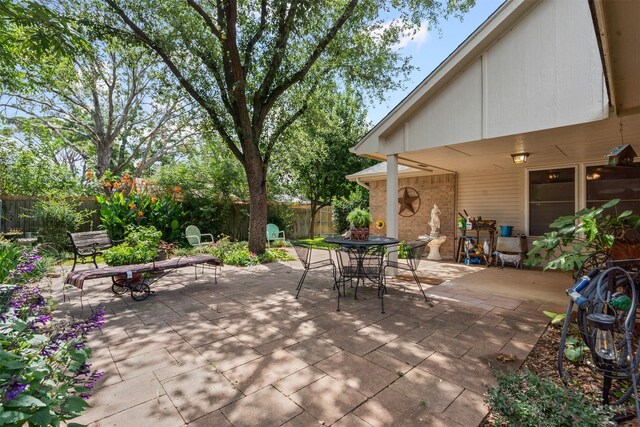 9013 Topperwind Ct, Fort Worth, TX 76134 - fenced backyard featuring outdoor dining area and a patio area