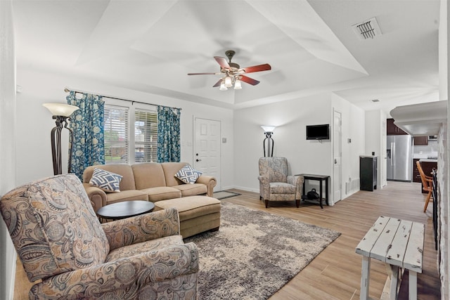 9013 Topperwind Ct, Fort Worth, TX 76134 - living room with a tray ceiling, a ceiling fan, and light wood finished floors