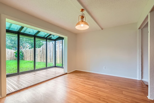 902 Via Valencia, Mesquite, TX 75150 - empty room with light wood-style floors, a textured ceiling, and a sunroom