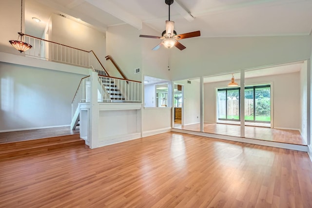 902 Via Valencia, Mesquite, TX 75150 - unfurnished living room featuring high vaulted ceiling, wood finished floors, stairway, a ceiling fan, and beamed ceiling